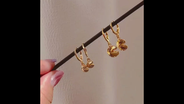 A short video of the Fortune Cookie Huggie Earrings next to the mini equivalent.
