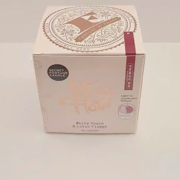 A video of the "Let go and flow." Secret Fortune candle being unboxed.