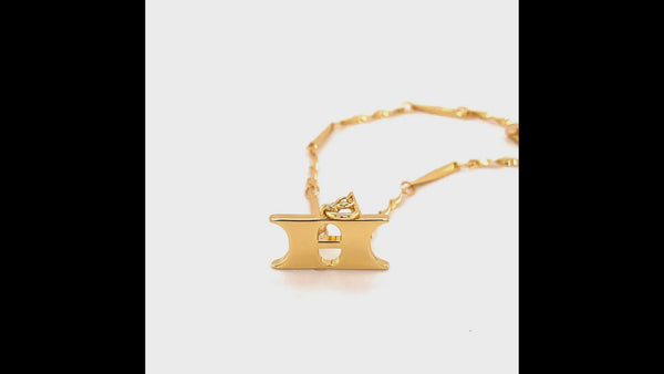A 360 video of the Letter 'H' Pendant Necklace. Video shows the 'H' pendant including the wave detail on the back and the gold twisted bar chain.