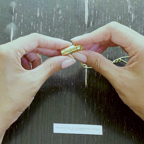 A video demonstration of how to roll the message that goes inside our gold capsule necklace