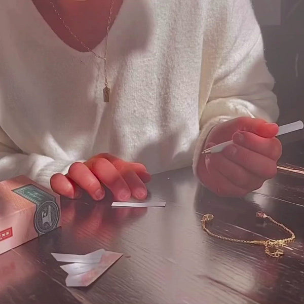 A girl writing a custom fortune and placing it inside our polygon bracelet. 